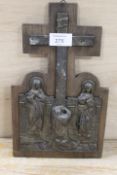 A CAST METAL RELIGIOUS SCENE MOUNTED ON A WOODEN PLAQUE