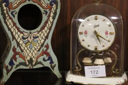 A CARRIAGE CLOCK TOGETHER WITH A PAINTED WOODEN POCKET WATCH STAND (2)