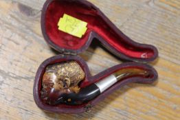 A VINTAGE MEERSCHAUM PIPE IN THE SHAPE OF A BLACK BOY IN A LEATHER COVERED CASE