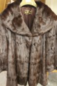 TWO VINTAGE FUR COATS COMPRISING A SWING STYLE BY JOHN DUNN & SONS OF DORKING AND SHORT BOLERO STYLE