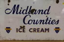 A VINTAGE MIDLAND COUNTIES ENAMEL ADVERTISING SIGN