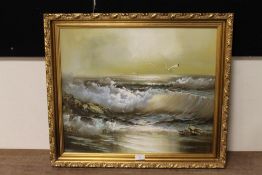 A GILT FRAMED OIL ON CANVAS OF BREAKING WAVES ON A BEACH