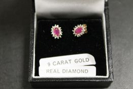 A PAIR OF A RUBY AND DIAMOND SET EARRINGS