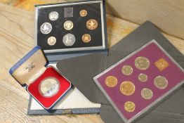 TWO CASED SETS OF COLLECTORS COINS - 1970 AND 1984 TOGETHER WITH A 1977 CROWN