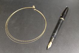 A HALLMARKED 9CT GOLD THREE STRAND NECKLACE TOGETHER WITH A 14 CT GOLD NIBBED FOUNTAIN PEN (2)