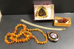 AN ANTIQUE ENAMEL GEMSET PENDANT LOCKET A/F, TOGETHER WITH A MODERN GRADUATED AMBER NECKLACES,