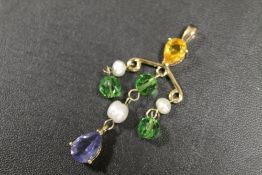 A GILT METAL PENDANT SET WITH SEED PEARLS AND COLOURED STONES