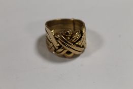 A GENTLEMAN'S YELLOW METAL PUZZLE RING