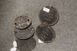 A SELECTION OF FIVE CAST METAL OVAL WAGON PLATES ;