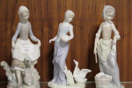 A NAO FIGURE OF A GIRL WITH A RABBIT TOGETHER WITH TWO SIMILAR FIGURES (3)
