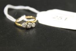 AN UNMARKED YELLOW METAL THREE STONE ILLUSION SET DIAMOND RING - APPROX WEIGHT 2.8G