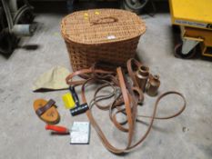 A VINTAGE WICKER BASKET AND CONTENTS TO INCLUDE HORSE TACK