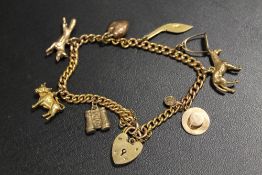 A HALLMARKED 9CT GOLD CHARM BRACELET AND CHARMS, TO INCLUDE EQUESTRIAN EXAMPLES - APPROX WEIGHT 23.9