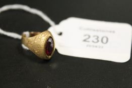 A MARQUISE SHAPED CONTINENTAL RING STAMPED 750 SET WITH A RUBY STYLE STONE - APPROX WEIGHT 4 G