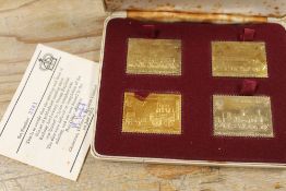 A CASED SET OF FOUR HALLMARKED SILVER GILT LOCOMOTIVE THEMED MEDALLIONS - APPROX COMBINED WEIGHT