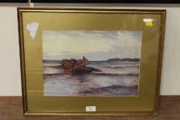 A GILT FRAMED AND GLAZED WATERCOLOUR OF TWO FISHERMEN IN A BOAT ON THE SHORELINE, SIGNED LOWER RIGHT