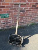 AN ANTIQUE PUSH MOWER