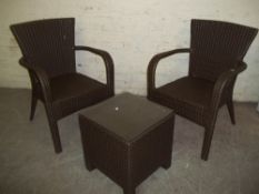 A PAIR OF MODERN UPVC RATTON GARDEN CHAIR AND A TABLE