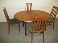 A RETRO TEAK DANISH EXTENDING DINING SET WITH 4 CHAIRS