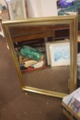 A GILT FRAMED MIRROR 114 CM X 90 CM