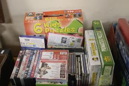 A TRAY OF ASSORTED CDS, JIGSAWS, DVDS ETC (TRAY/S NOT INCLUDED)