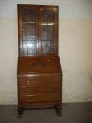 A LEATHER INLAID OAK BUREAU BOOKCASE