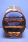 AN OAK OVAL SHAPED BRASS BOUND WINE RACK H 56 CM W 38 CM D 33 CM