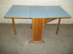 A RETRO BLUE DROP LEAF KITCHEN TABLE