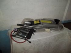 A 2 T0NNE CAR TROLLEY AND A FOOT PUMP