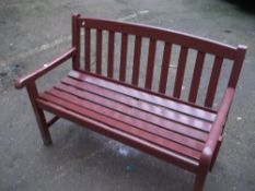 A SOLID WOODEN GARDEN BENCH