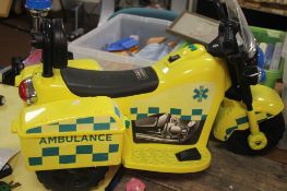 A CHILD'S BATTERY POWERED AMBULANCE MOTORBIKE