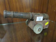 A VINTAGE DESK CANNON ON LATER WOODEN WHEELED BASE