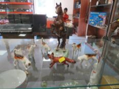 A BESWICK REARING HUNTSMAN TOGETHER WITH FIVE FOX HOUNDS AND A RUNNING FOX (7)