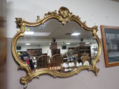 A 19TH CENTURY GOLD GILDED CARVECD WOODEN WALL MIRROR WITH PEARL AND SHELL CENTRAL FINIAL- W-115 CM