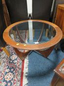 A MID CENTURY 'E-GOMME' FOR G-PLAN TEAK AND GLASS COFFEE TABLE DIA. 84 CM