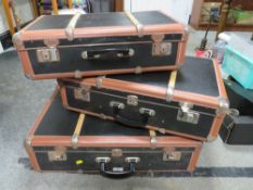 A SET OF THREE VINTAGE BANDED SUITCASES