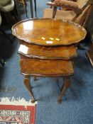 A WALNUT NEST OF THREE TABLES (WITH PIE CRUST BOARDER TO TOP TABLE)