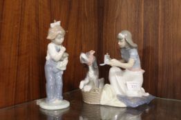 A VINTAGE LLADRO FIGURINE OF A GIRL NURSING HER DOG TOGETHER WITH A NAO FIGURE (2)