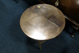 A SMALL CIRCULAR COPPER TOPPED TABLE