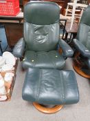 AN EKORNES STRESSLESS ARM CHAIR AND FOOTSTOOL