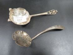 A HALLMARKED SILVER SIFTER LADLE TOGETHER WITH A SILVER PLATED EXAMPLE (2)