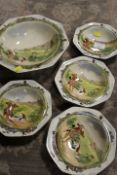 A ROYAL DOULTON FRUIT SET DECORATED WITH HUNTING SCENES CONSISTING OF FOUR SMALLER BOWLS AND A