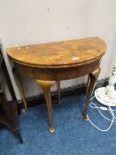 A 20TH CENTURY FOLD-OVER WALNUT DEMI-LUNE CARD TABLE DIA. 84 CM