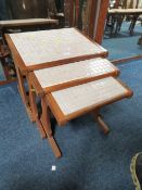 A RETRO TEAK TILE TOP NEST OF THREE TABLES