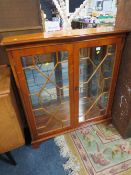 A REPRODUCTION YEW WOOD TWO DOOR GLAZED BOOKCASE