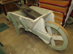 A VINTAGE WOODEN GARDEN BARROW TOGETHER WITH TROUGHS