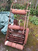 A LARGE VINTAGE CAST PETROL MOWER