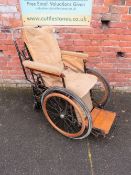 A VINTAGE INVALID CARRIAGE WITH WOODEN BANDED WHEELS