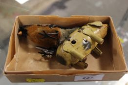A SMALL BOX CONTAINING A CLOCKWORK TINPLATE PIG AND A CLOCKWORK BIRD (2)