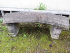 A CURVED CONCRETE GARDEN BENCH